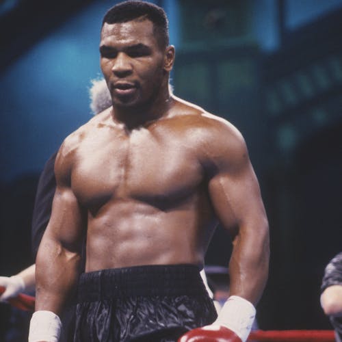 Mike Tyson stands during a fight in the ring