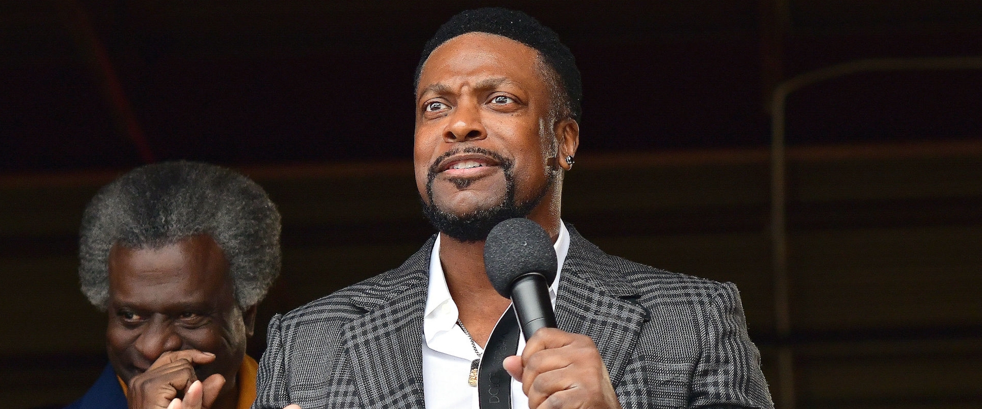 Afemo Omilami and Chris Tucker speak at the grand opening ceremony at Hosea Helps, INC Headquarters on October 28, 2021 in Atlanta, Georgia.