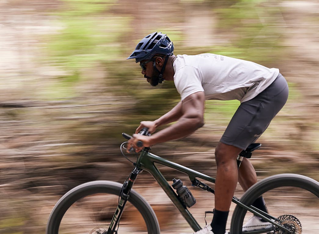 Man mountain biking wearing Barton sunglasses