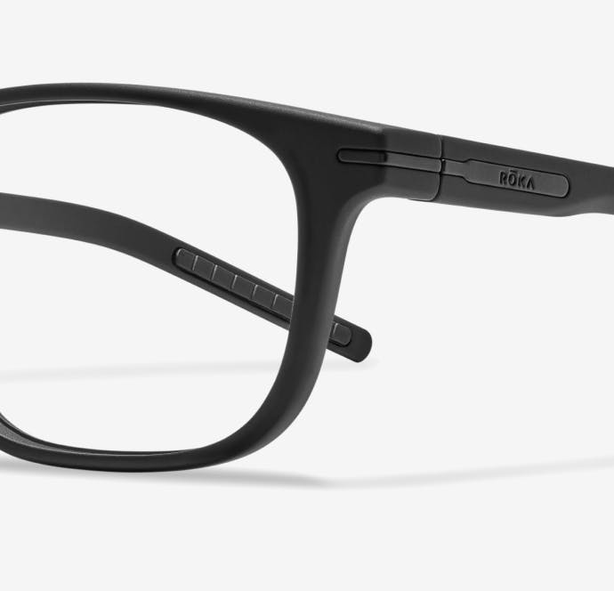 Angled view of rectangular, matte black Cade eyeglasses