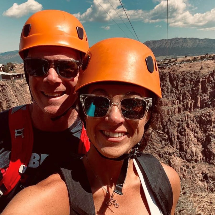 Man and woman hiking with helmets