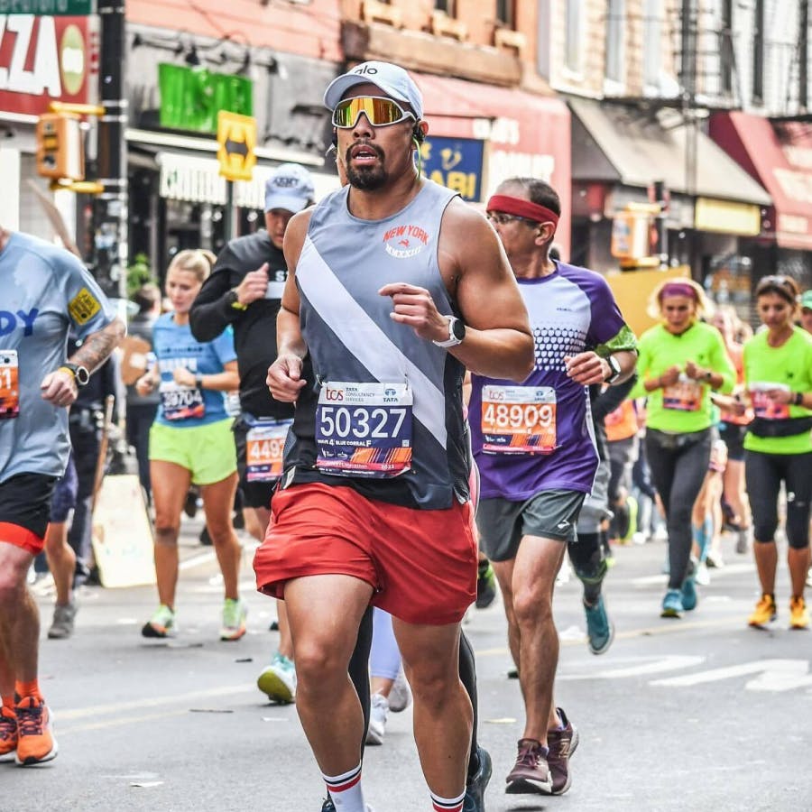 Man running marathon in city street