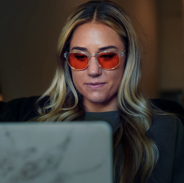 Woman working on her laptop wearing ROKA eyeglasses