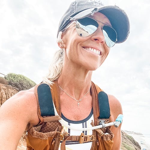 Woman smiling wearing backpack and ROKA aviator sunglasses