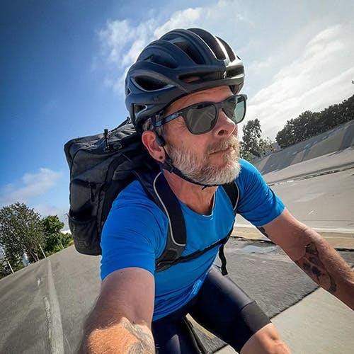 Man riding bike with backpack