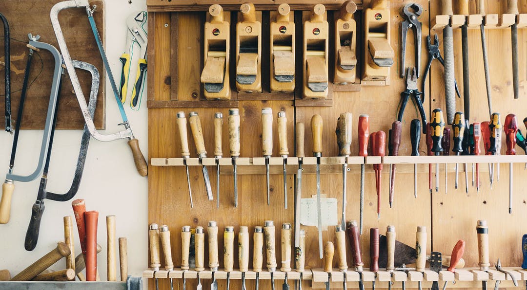 workshop with lots of tools hanging on the wall