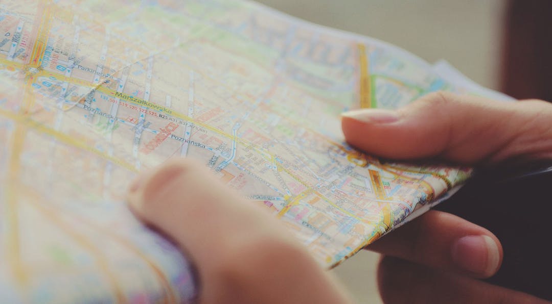 close up of a person holding a street map