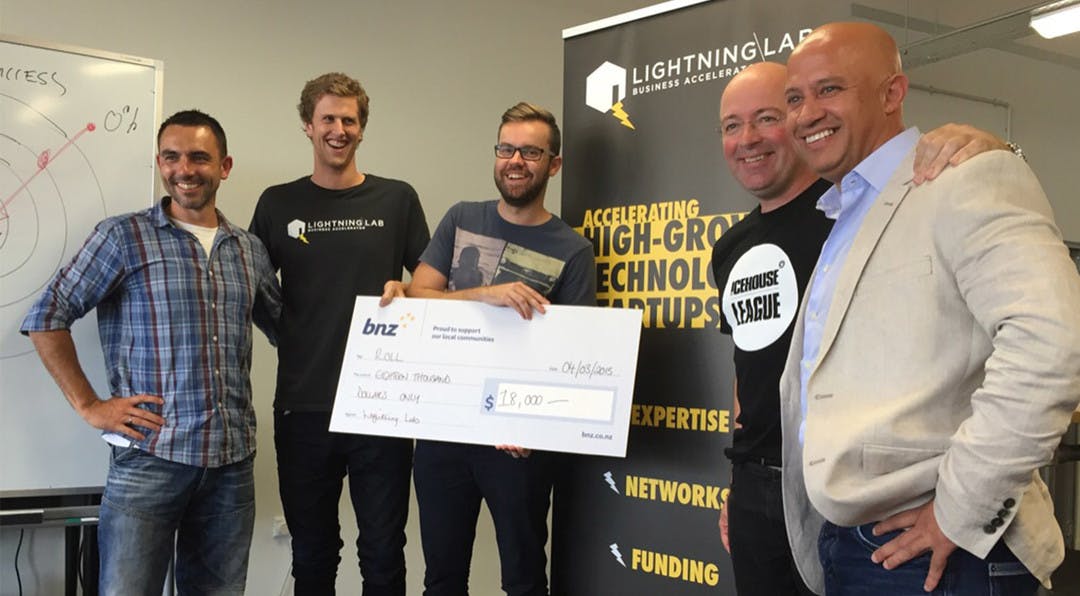 The team at Roll are being presented with a cheque from Lightning Lab for being chosen as one of the 9 most promising tech startups in New Zealand