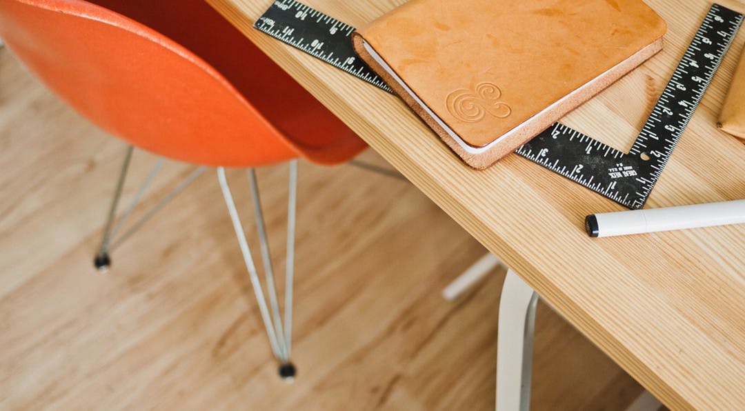 diary sitting on a table along with an empty chair