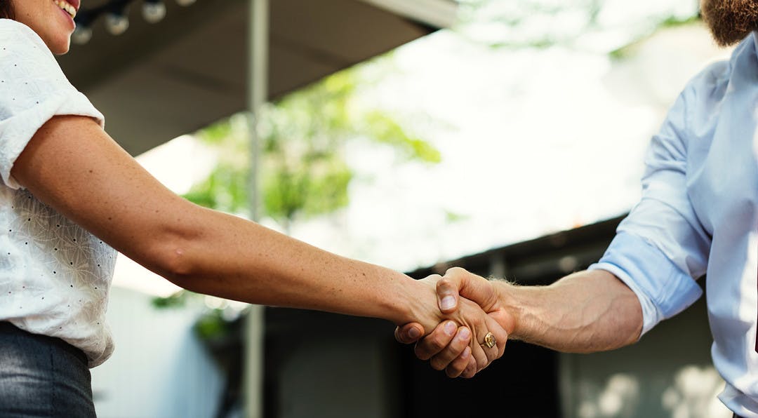 two people are shaking hands