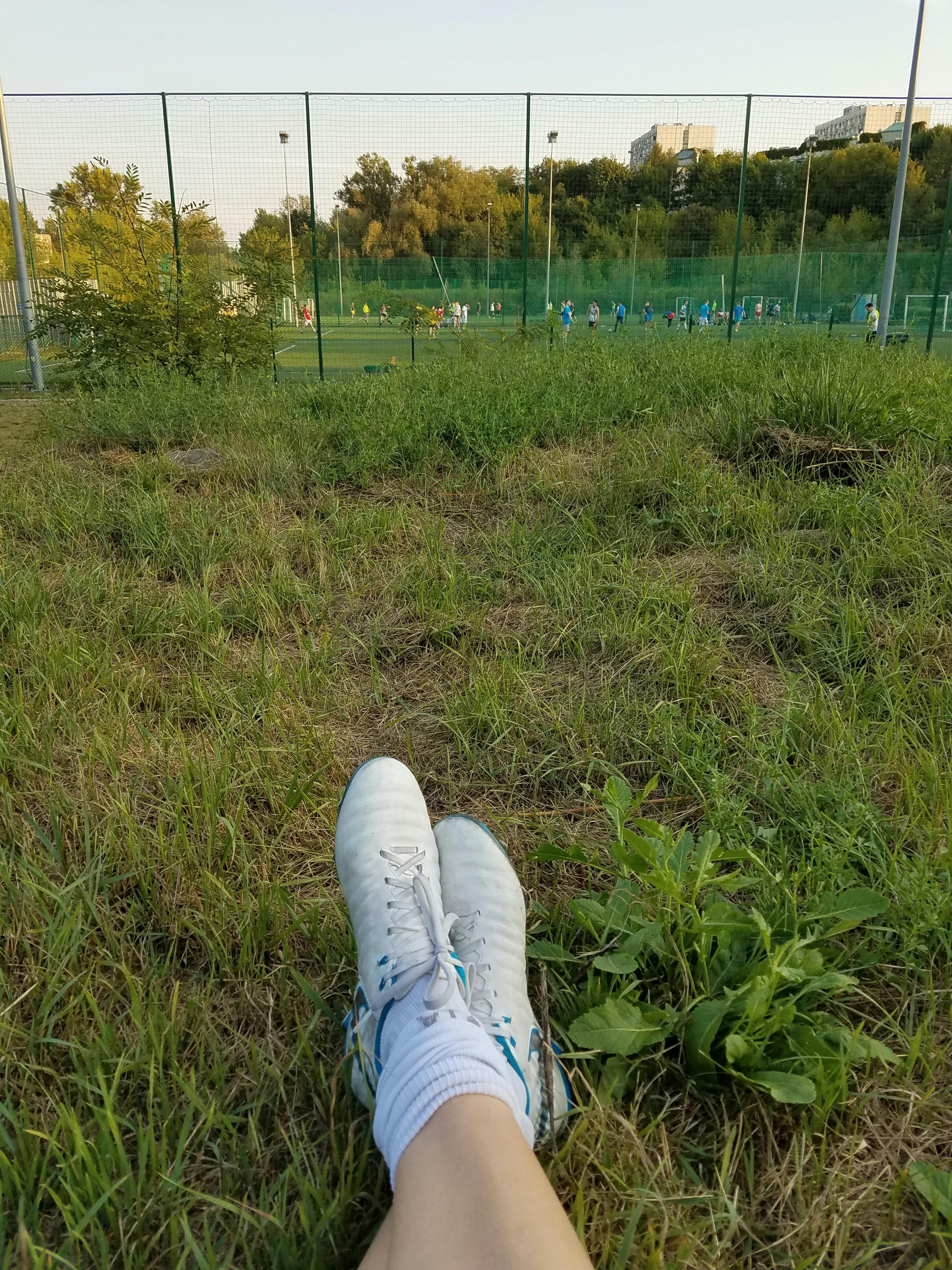 soccer cleats with field in background