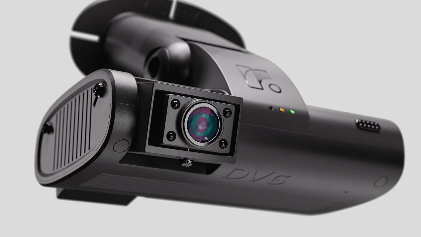 Close-up of black DVS dashcam with lens and LED indicators, designed for vehicle safety monitoring.