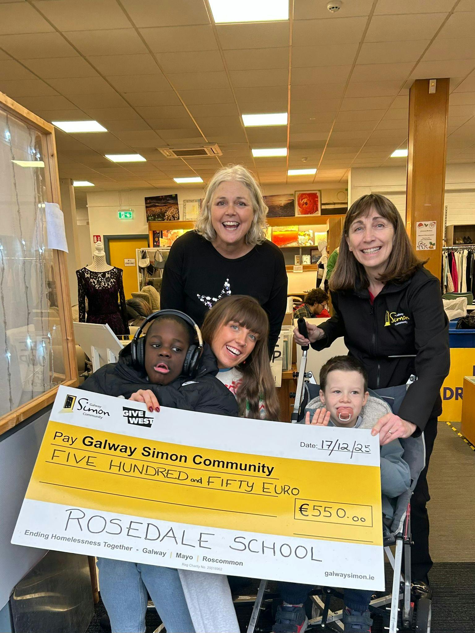 Teacher Ellen with Students Jason and Daniel Presenting Christmas Jumper Day Funds to the Galway Simon Community