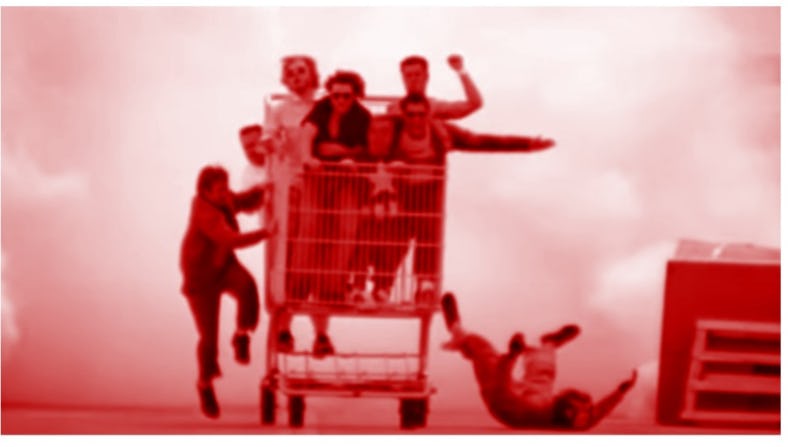 Men riding in a giant shopping cart.