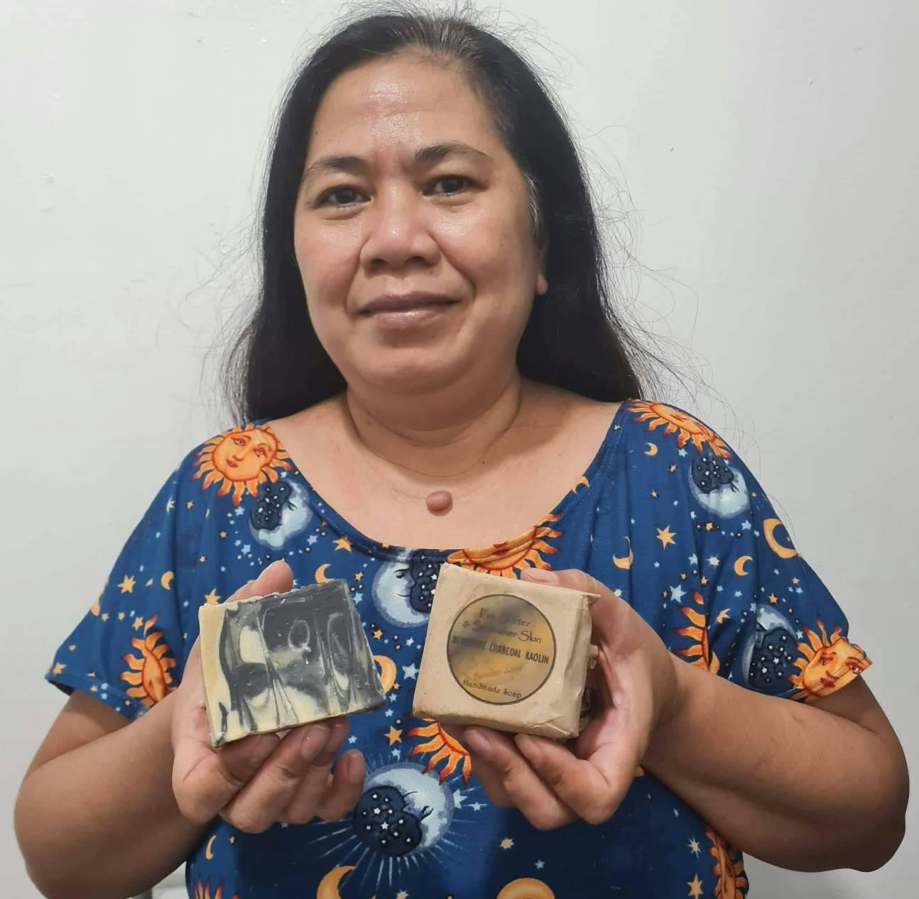 Espie De Villa, owner/operator of Mommy E's holding some of her skincare products