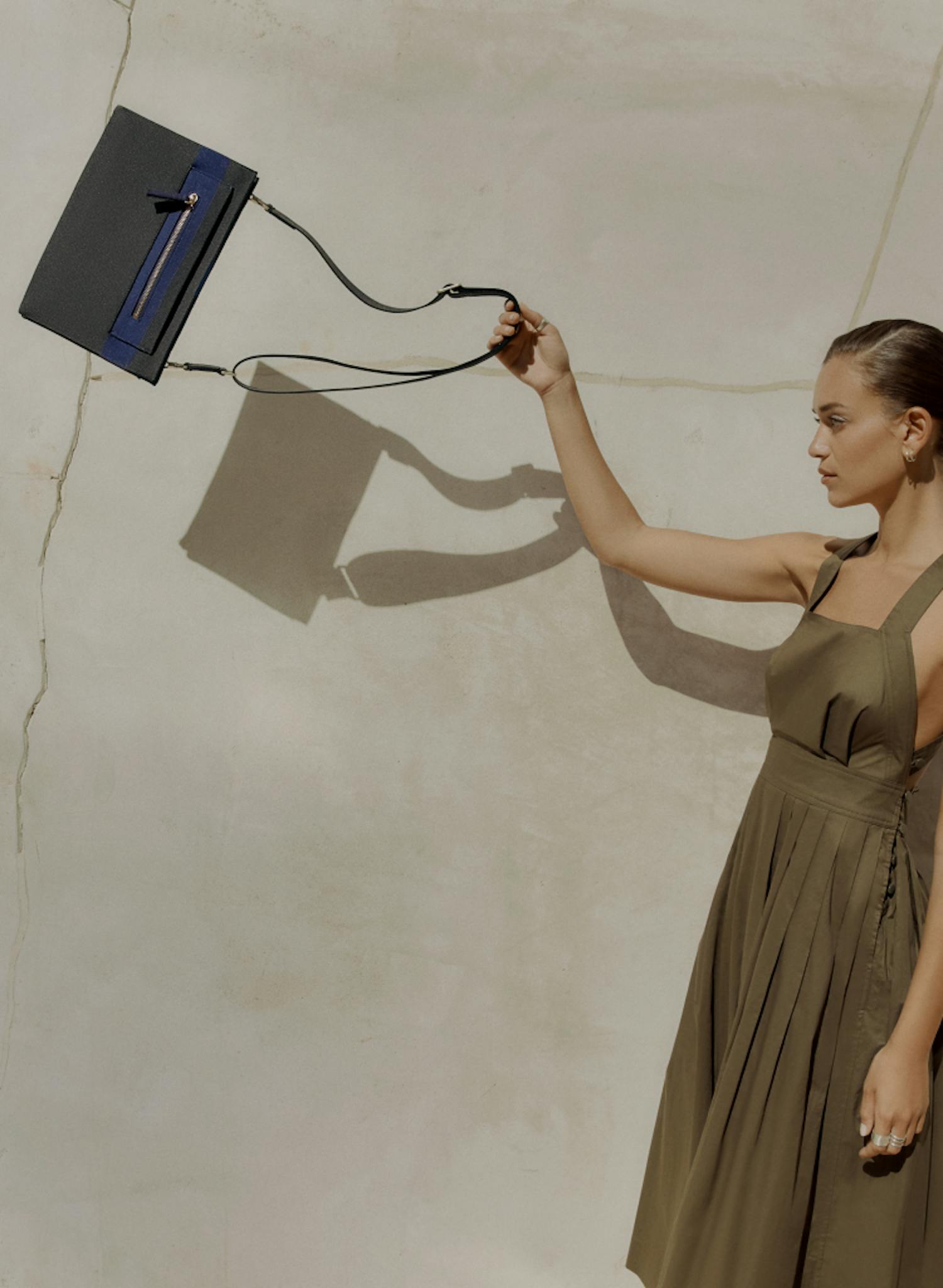 The Dual-Zip Crossbody in Slate Black shown with a model.