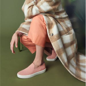 The Sneaker in Coral shown on-model.