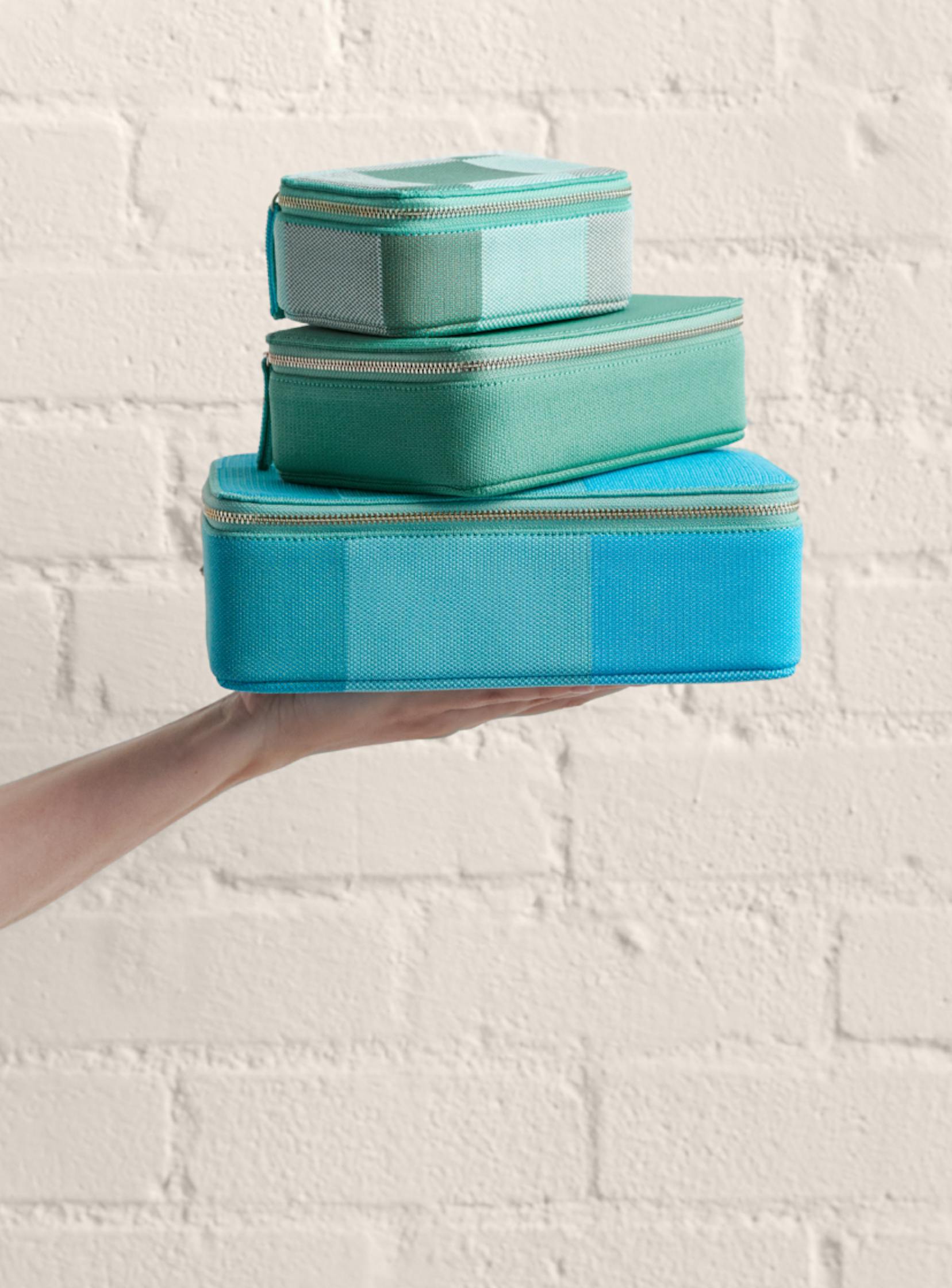 The Large Catchall in Caribbean Madras, The Mid Catchall in Juniper Green, The Mini Catchall in Juniper Madras shown stacked.