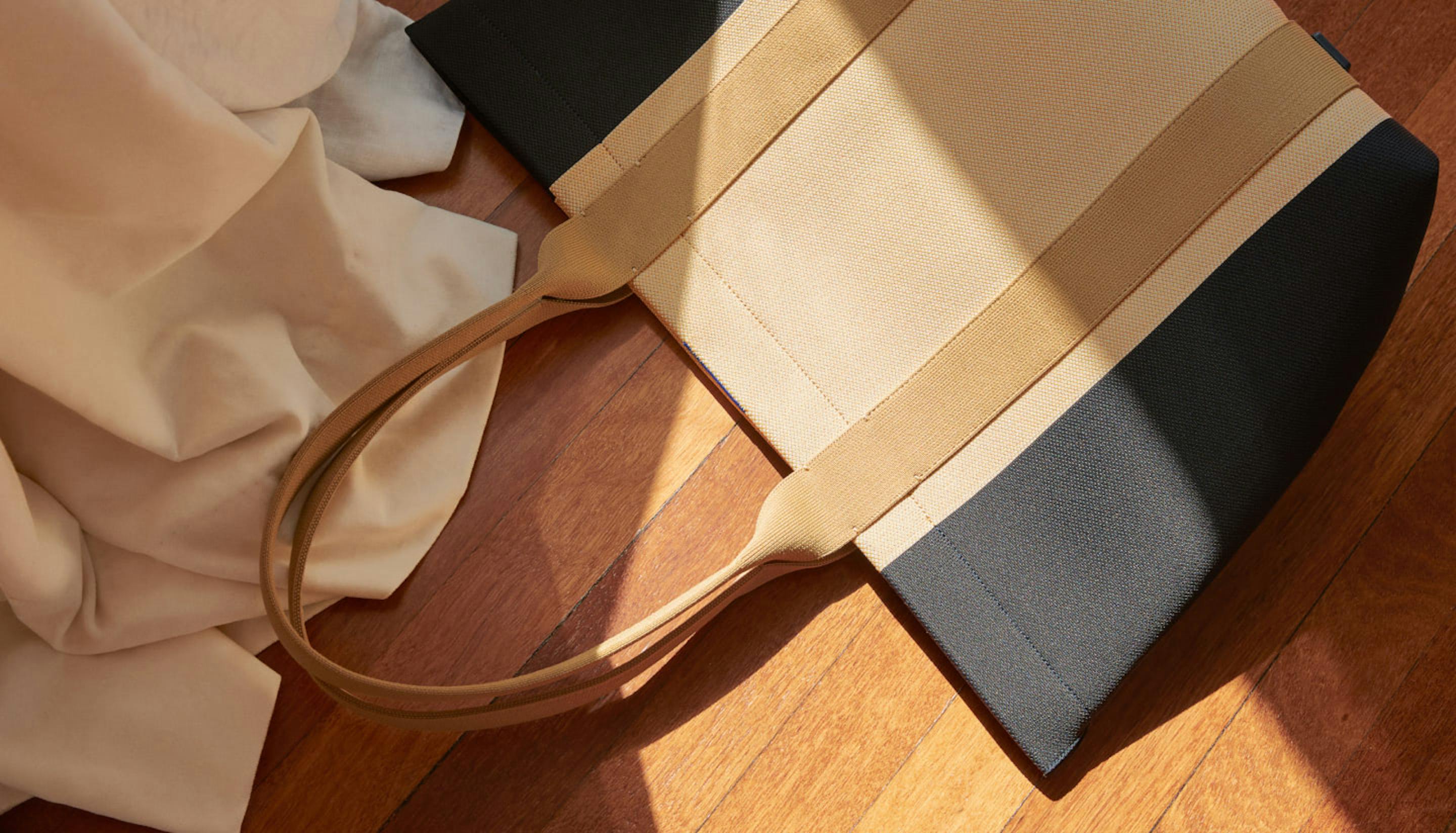 The Essential Tote in Ink & Ivory show from the top.