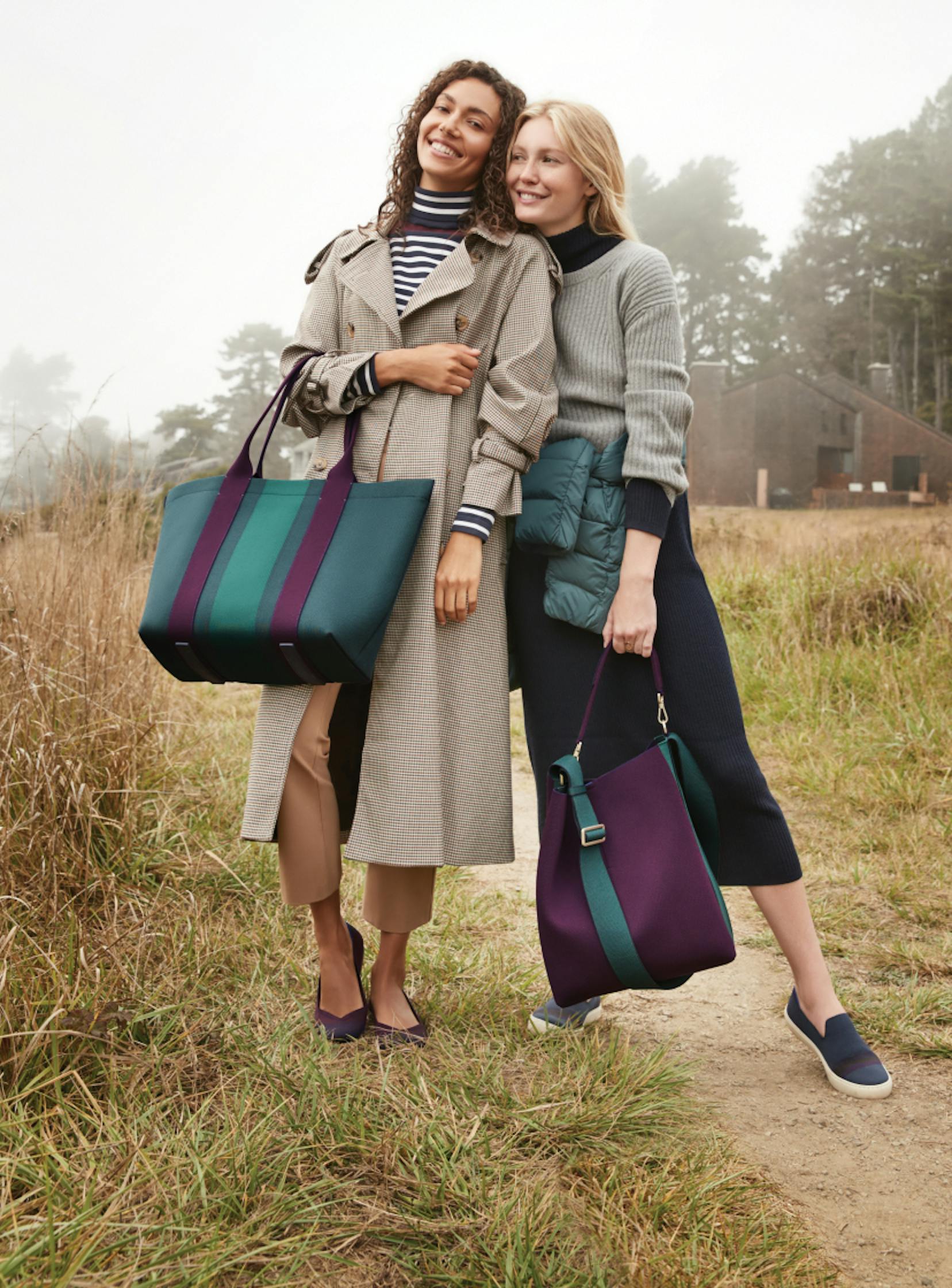 The Essential Tote in Deep Spruce and The Bucket Bag in Dark Plum held by models.