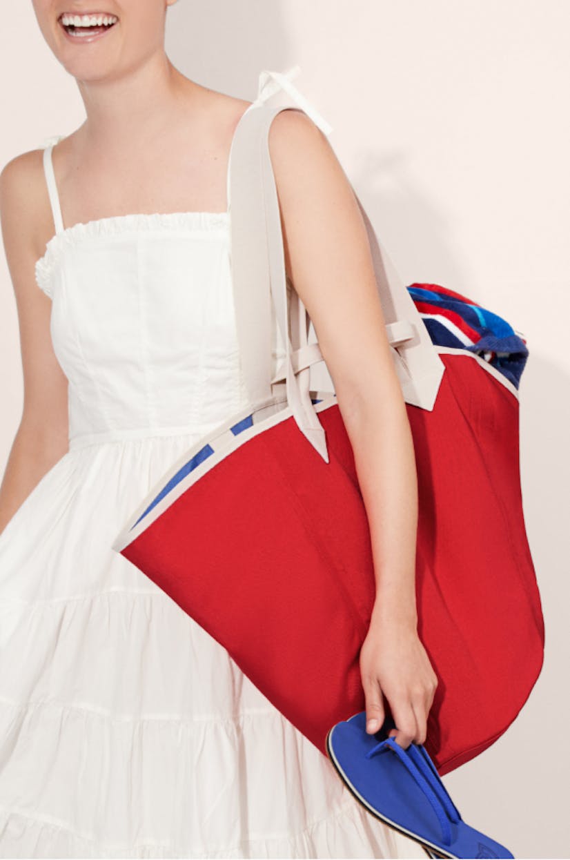 The Reversible Tote in Red & Cobalt and The Flip in Splash shown on model.