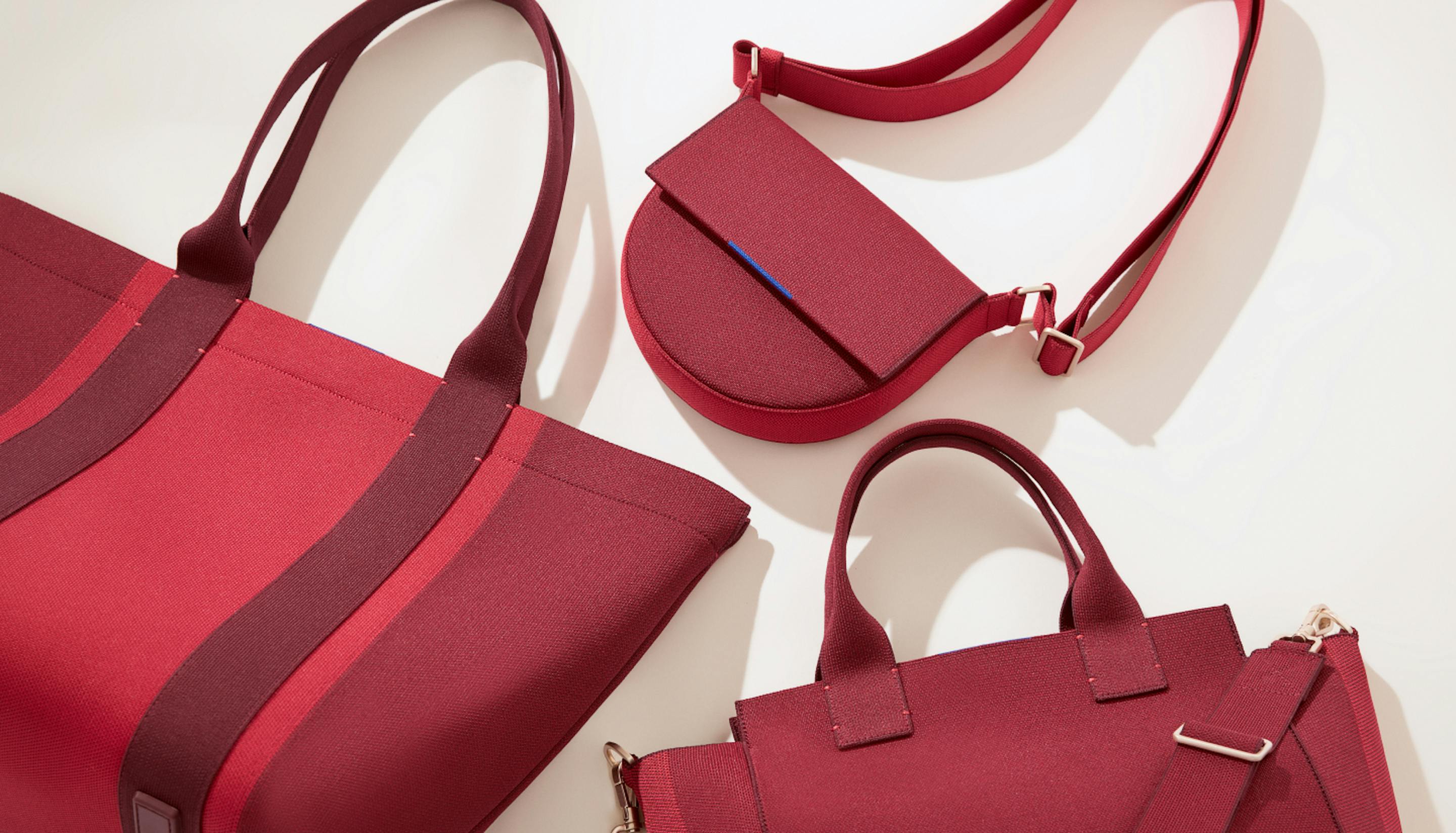 The Essential Tote, The Saddle Bag and The Handbag in Ruby Red shown from left to right.