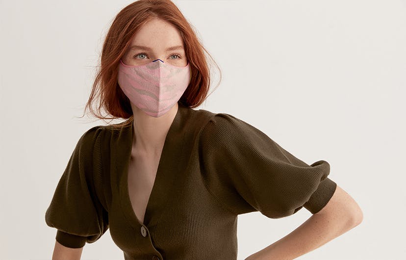 Model wearing The Mask 1.0 in Light Pink Camo.