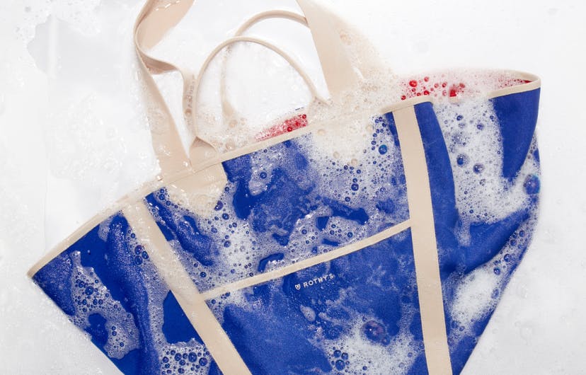 The Reversible Tote in Red & Cobalt shown wet with soap suds.