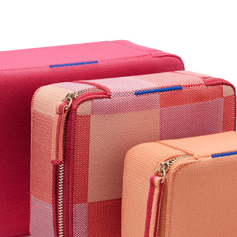 The Large Catchall in Bright Fuchsia, The Mid Catchall in Peach Madras and The Mini Catchall in Light Melon shown close up.