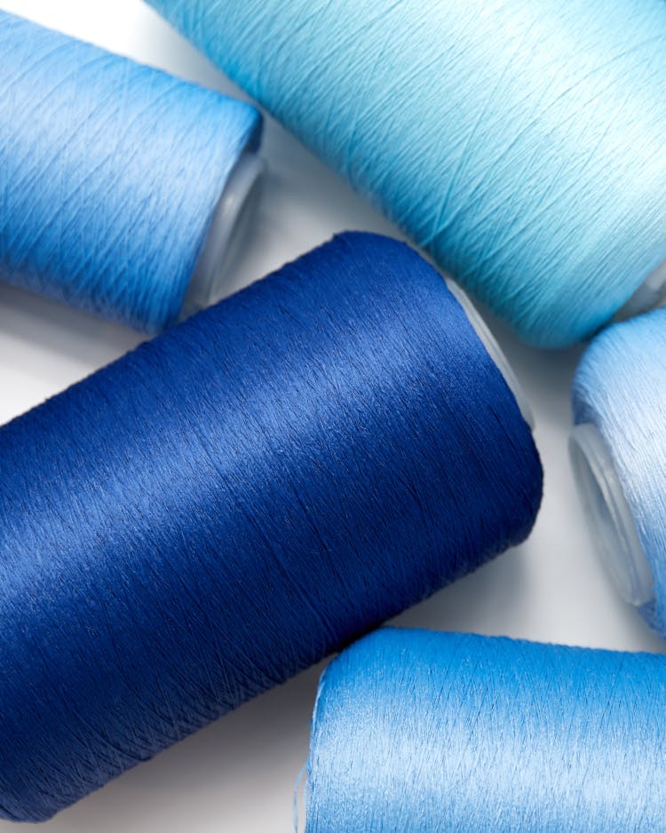 Pellets are made into spools of thread and knit into shoes.