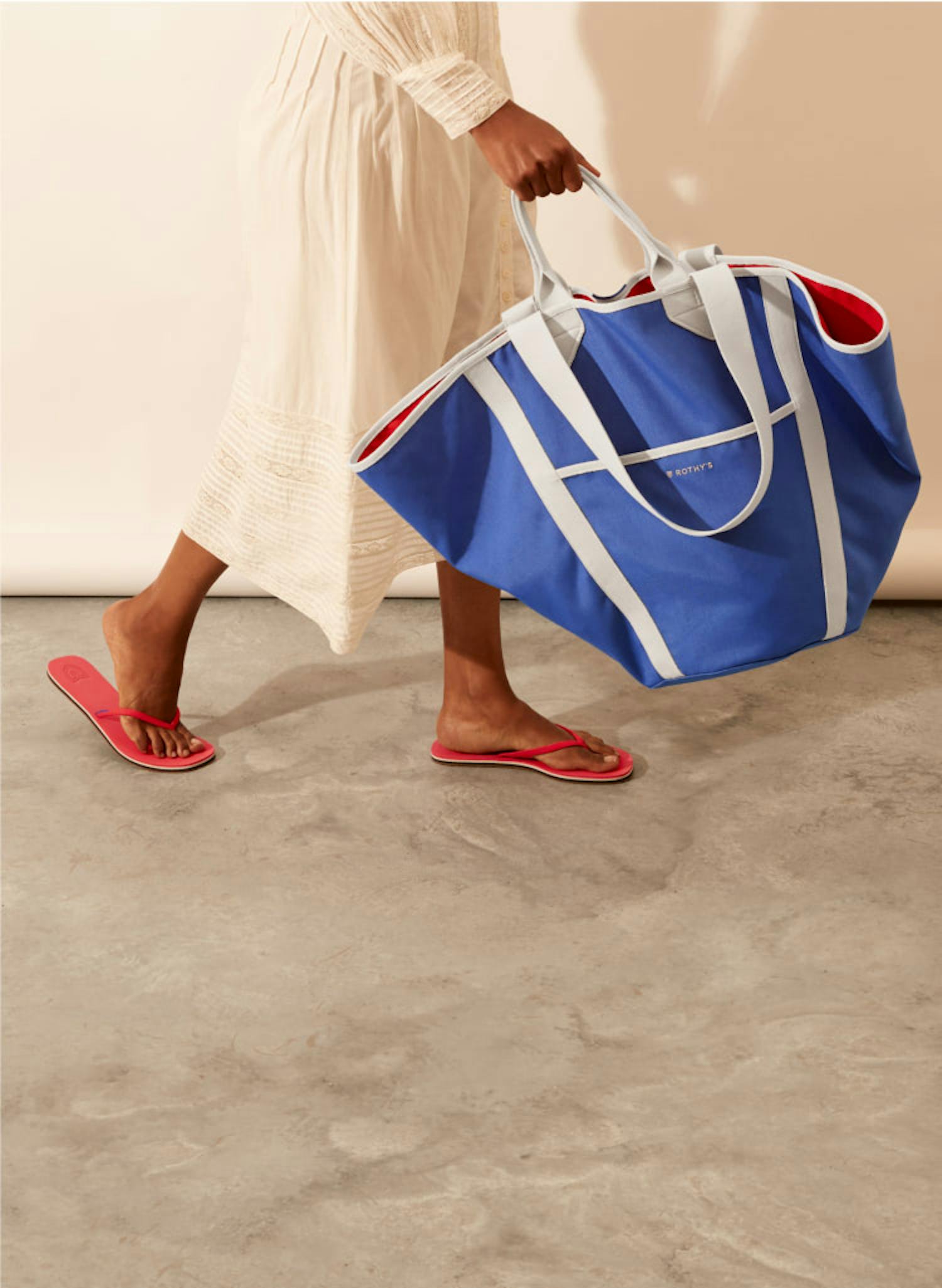 The Flip in Firecracker and The Reversible Tote in Red & Cobalt shown on-model.