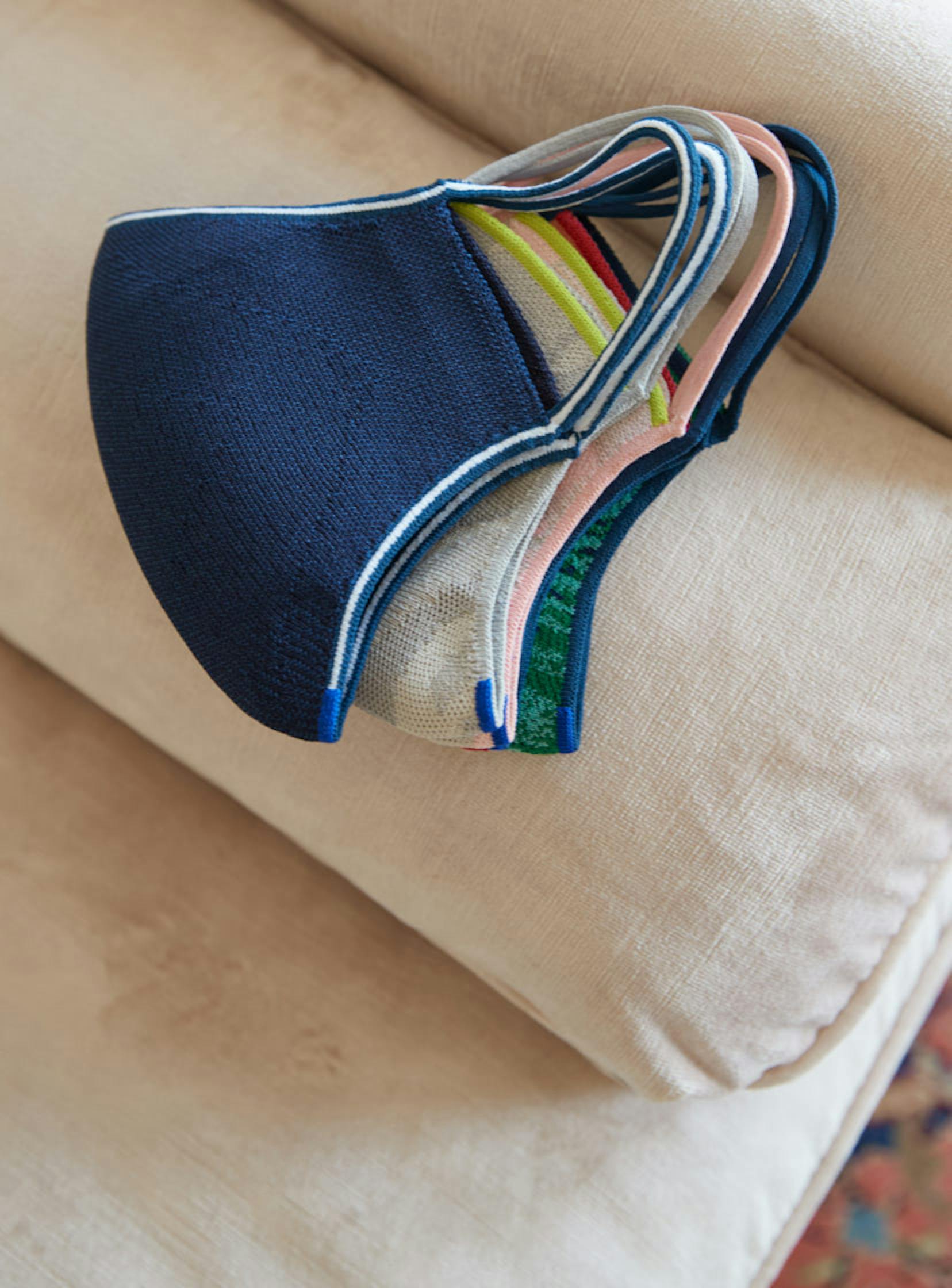 An assortment of The Mask 1.0, folded against a cream background.