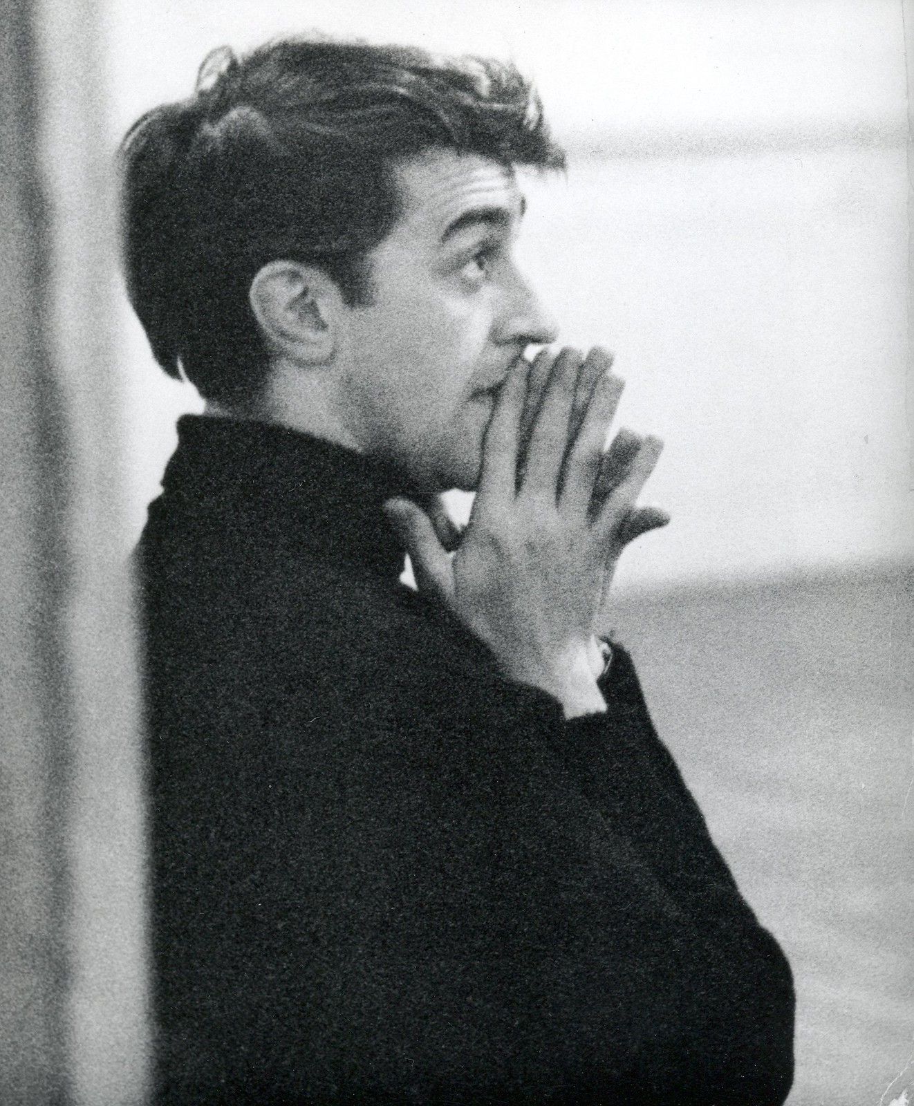 Kenneth MacMillan holding his hands together.