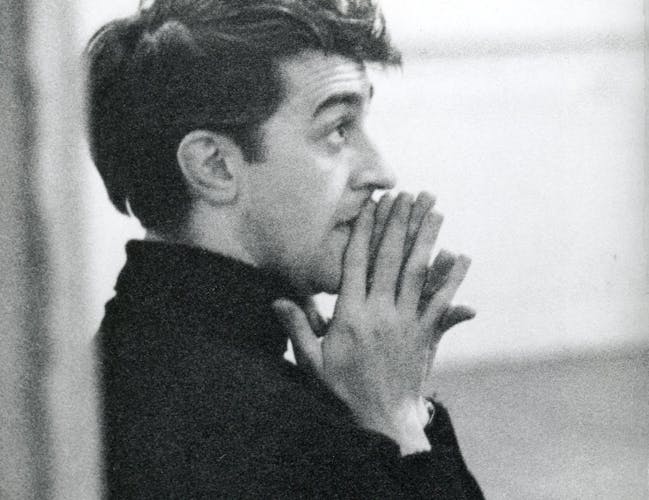 Kenneth MacMillan holding his hands together.