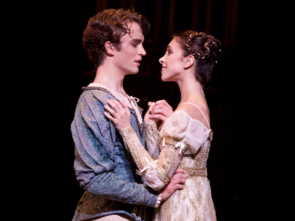 Ballet dancers performing onstage as Romeo and Juliet.