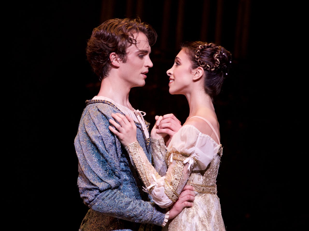 Ballet dancers performing onstage as Romeo and Juliet.
