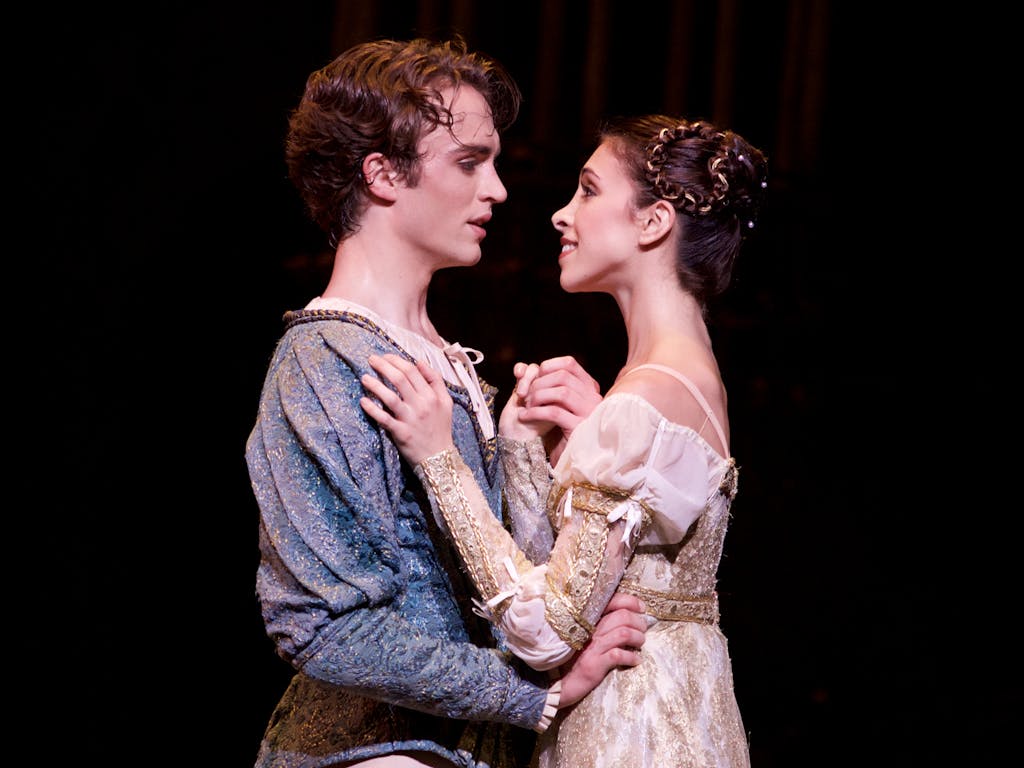 Ballet dancers performing onstage as Romeo and Juliet.