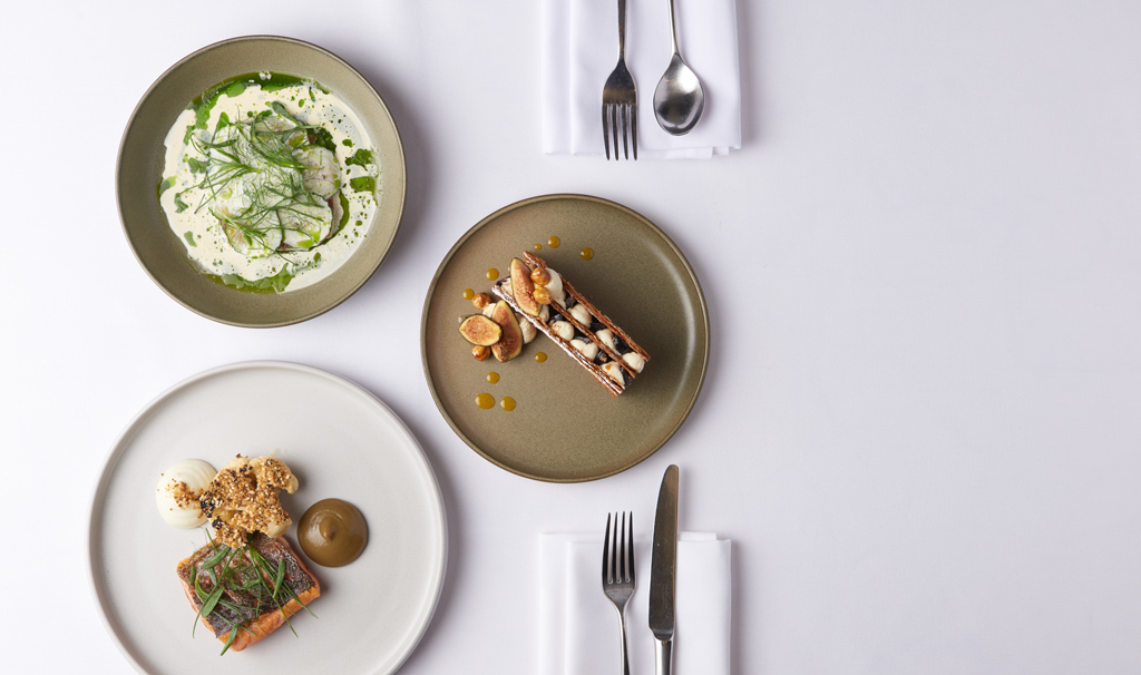 Tables laid out for dining in the modern and elegant Balconies Restaurant in the stunning Paul Hamlyn Hall, formerly the Covent Garden flower market.