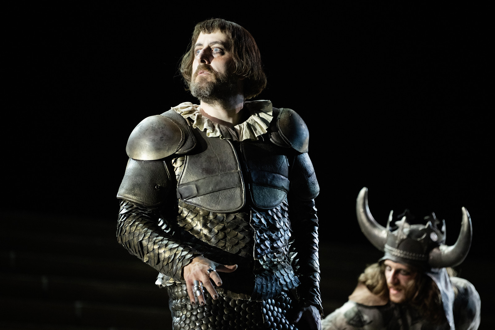 A cast member of Il Trovatore standing onstage during a performance.