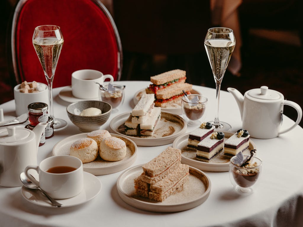 An afternoon tea selection arranged on a white tablecloth.