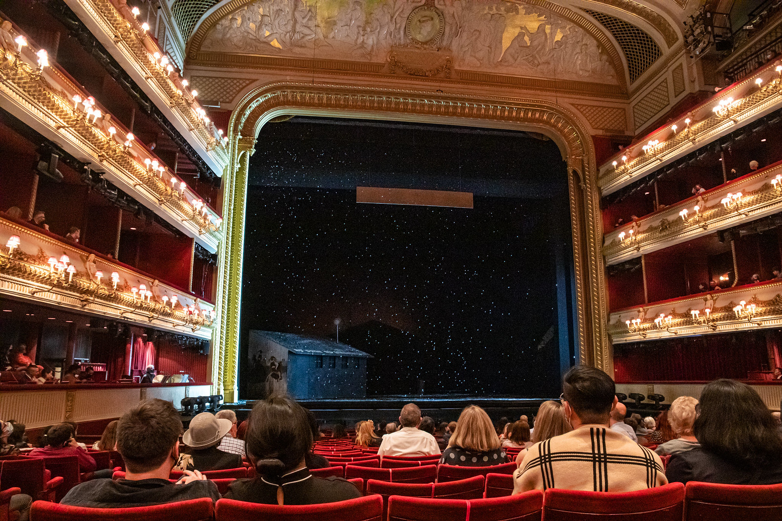 Snow falling on the main stage of the Royal Opera House during a performance.