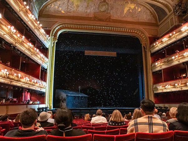 Snow falling on the main stage of the Royal Opera House during a performance.
