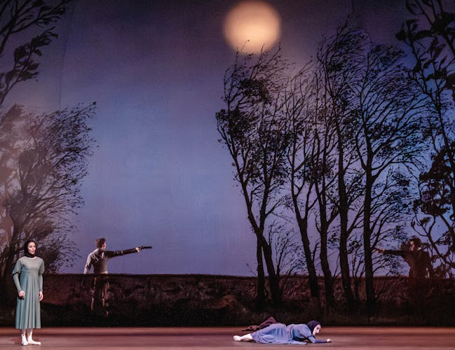 Two women stand in the foreground, despairing, while two men in the background raise their guns at each other.