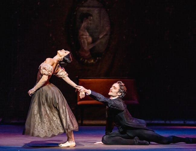 Yasmine Naghdi and Matthew Ball as Tatiana and Onegin. Onegin grasps onto Tatiana's hand in a final bid for her love, while Tatiana pulls away.