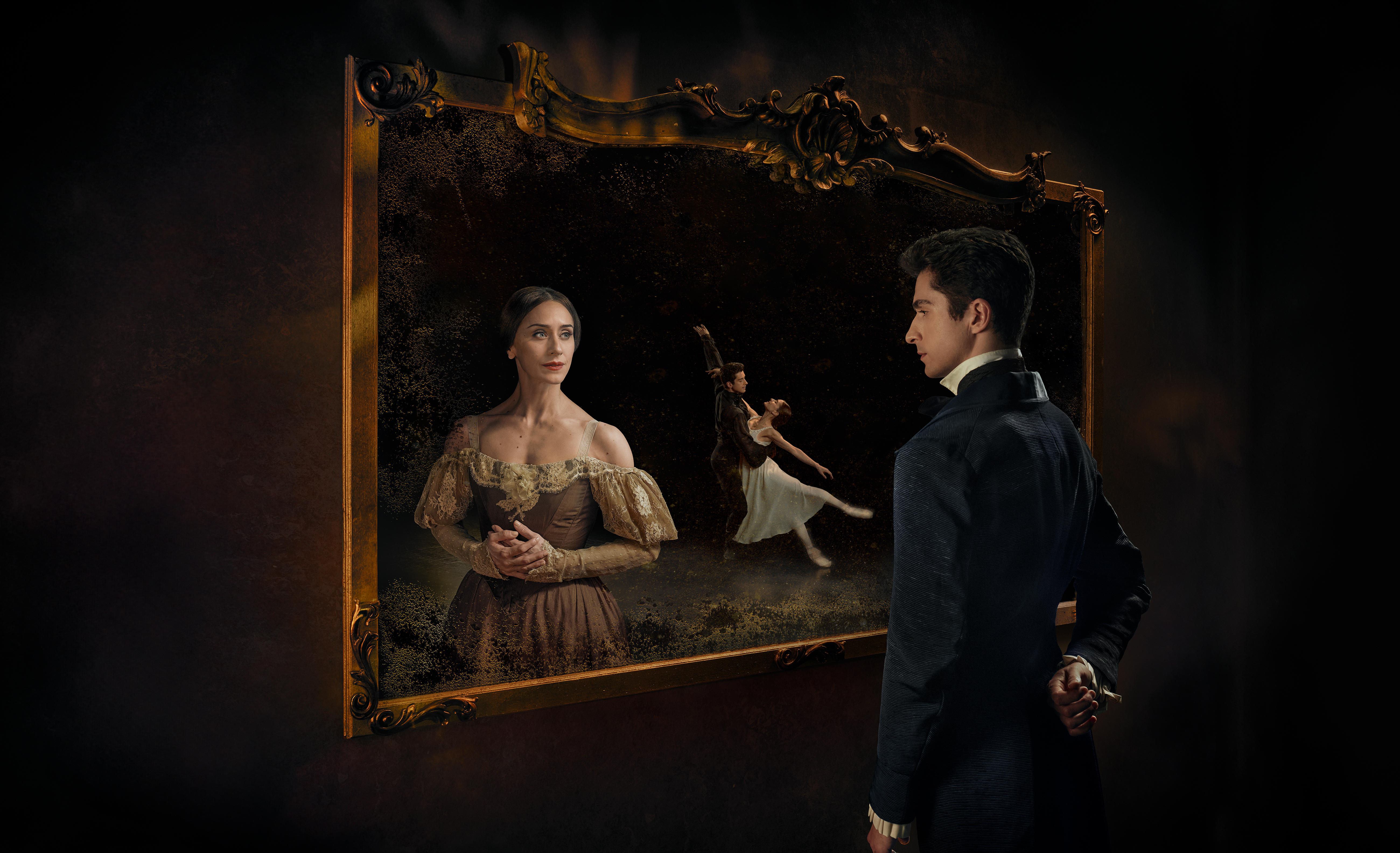 A person stares into a picture frame as another person in a decorative dress stares back. Behind them, two ballet dancers embrace.