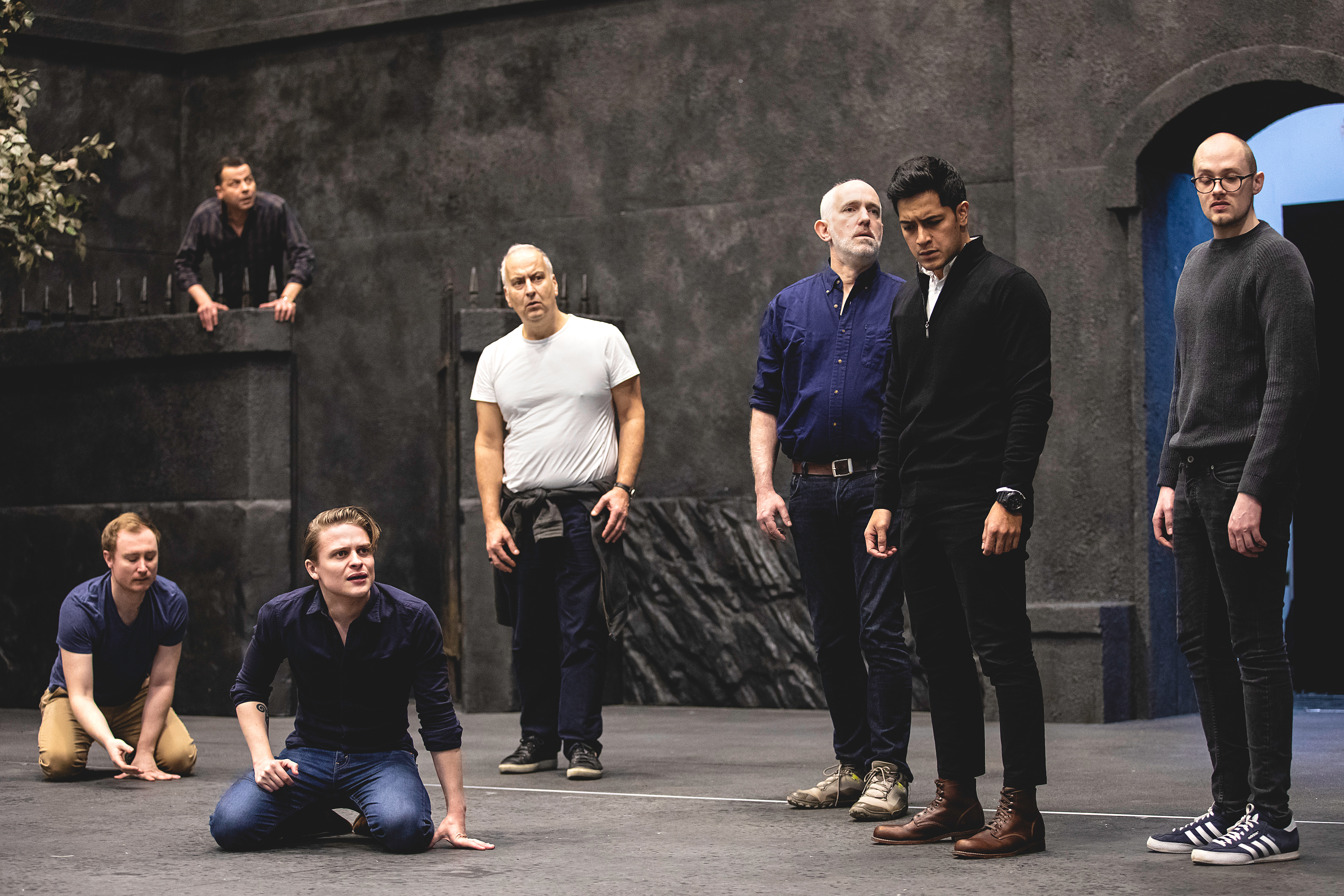 Singers stand on set in rehearsal for Fidelio