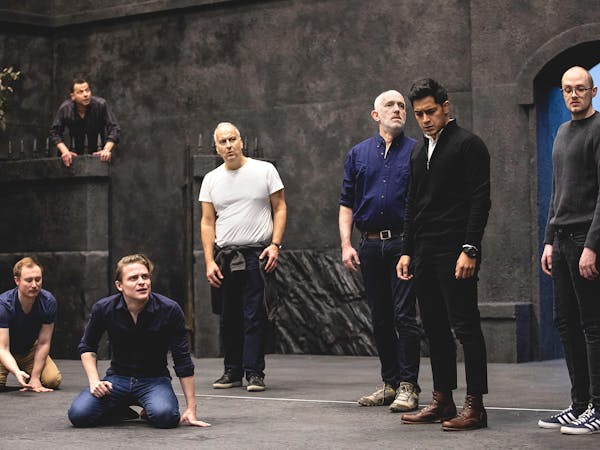 Singers stand on set in rehearsal for Fidelio