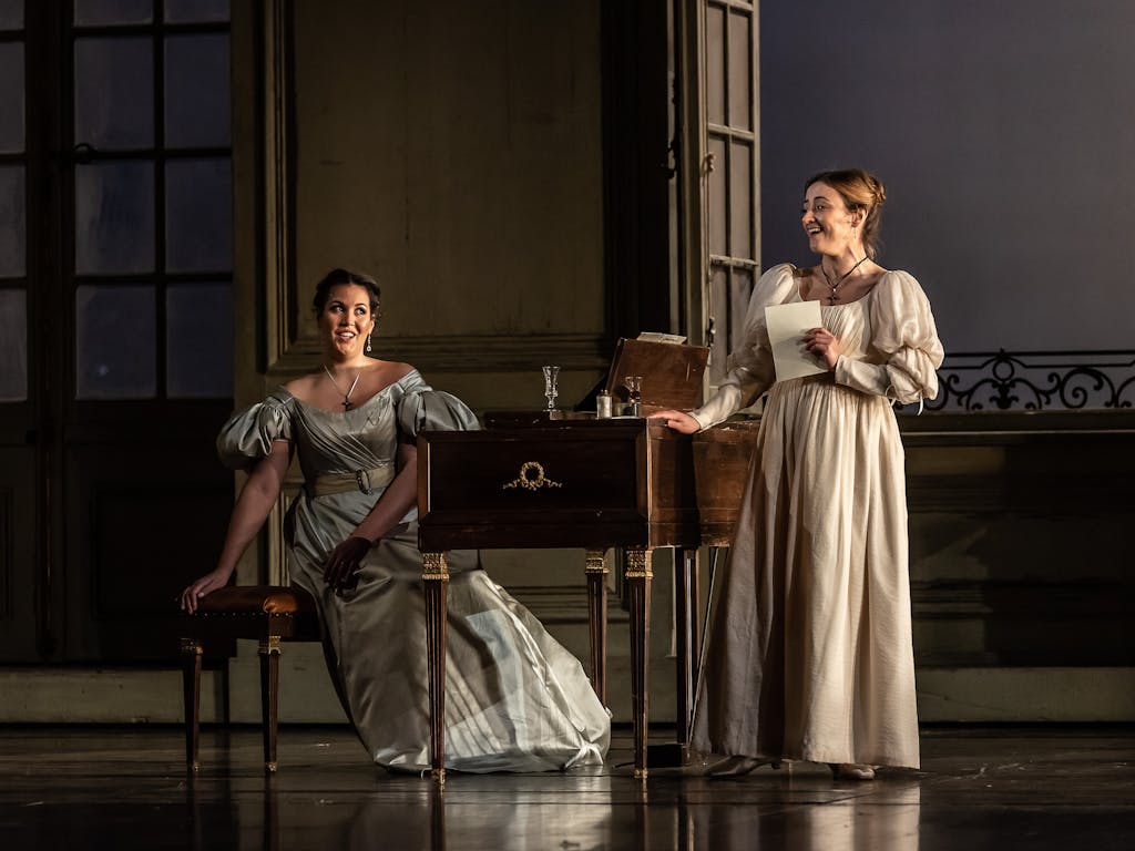 Two performers onstage at the Royal Opera House in a production of The Marriage of Figaro.