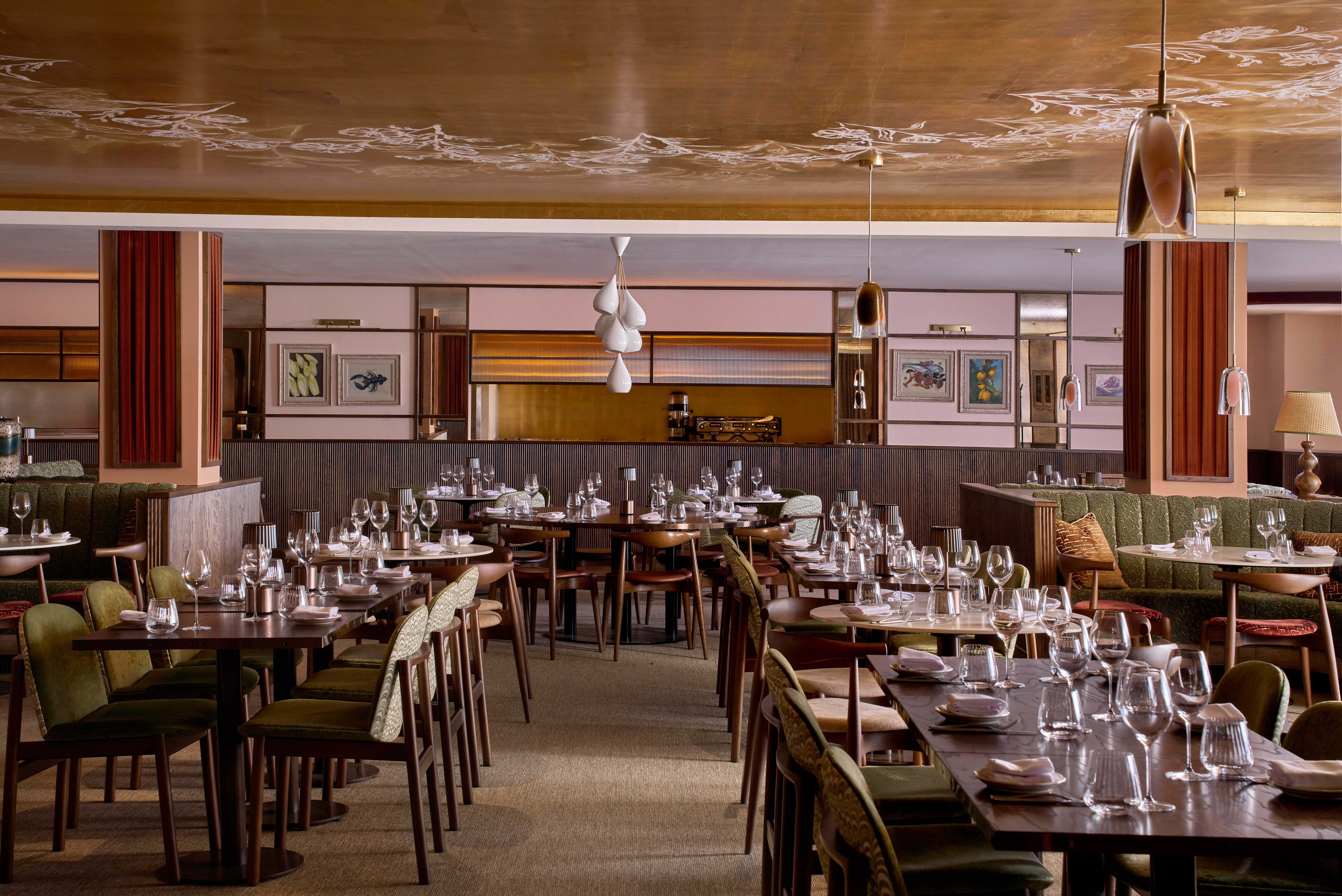 Spacious, elegant restaurant interior with neatly arranged wooden tables and green chairs. Warm lighting and decorative ceiling. 
