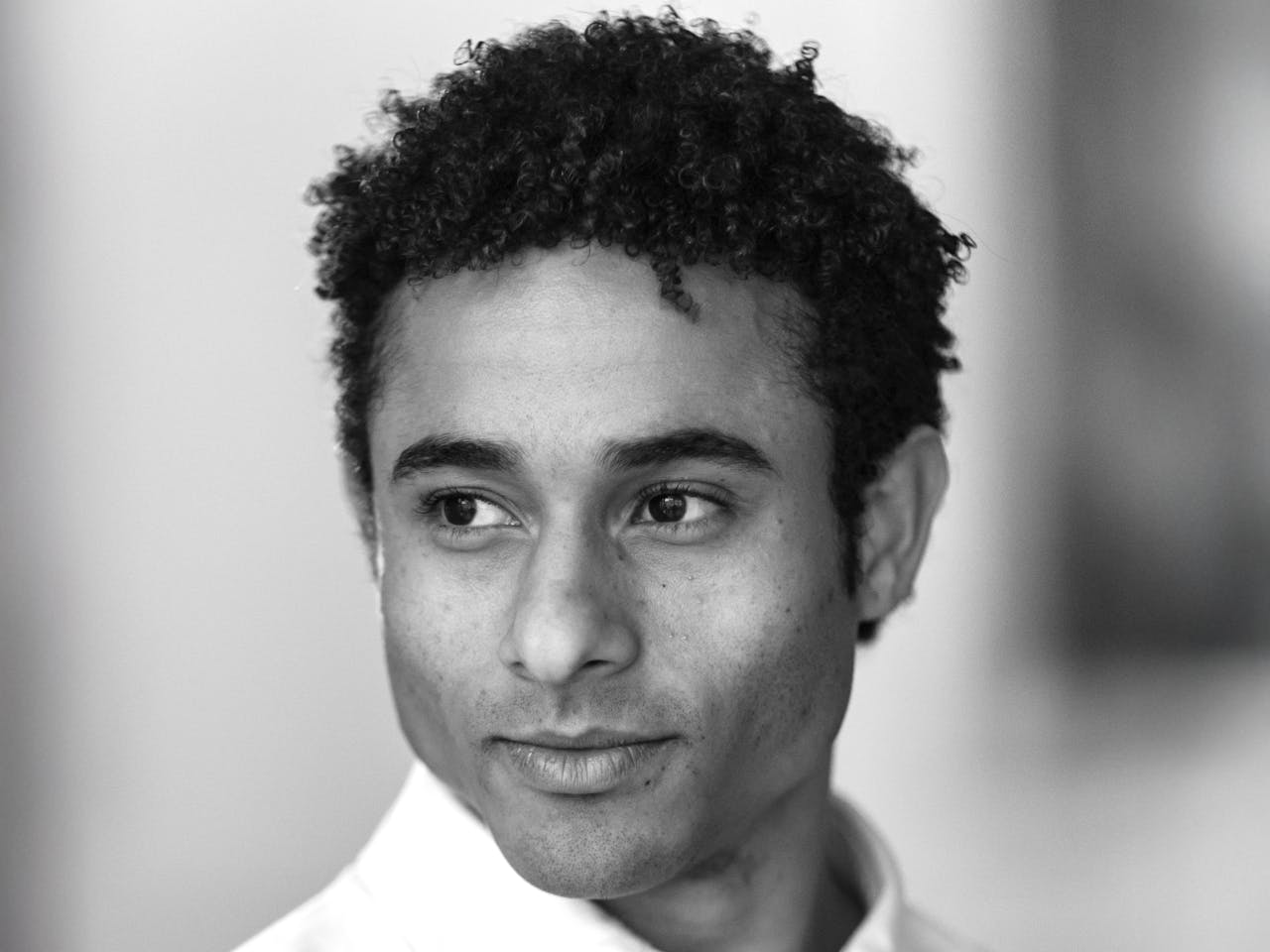 A black and white headshot of Patricio Revé